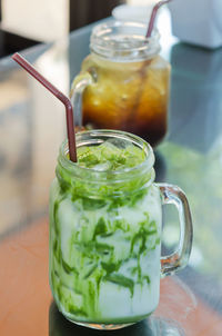 Close-up of drink in glass jar on table