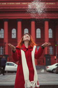 Close up woman throwing snow on street portrait picture