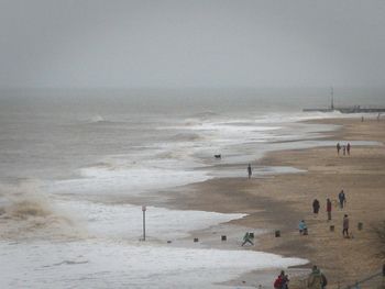 People on beach against sky