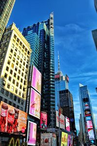 Low angle view of buildings against blue sky