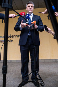 Full length portrait of a man standing outdoors