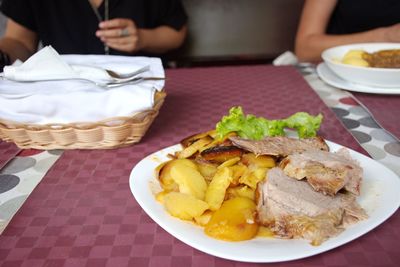 Closeup shot of meat and potatoes on the table in restaurant