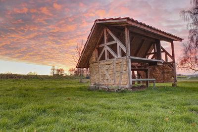 Old ruin on field against sky during sunset