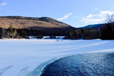 Scenic view of landscape against sky during winter