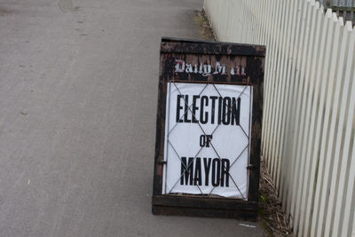 High angle view of sign on road in city