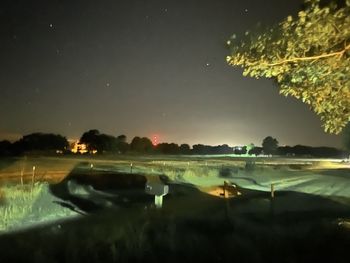 Scenic view of lake against sky at night