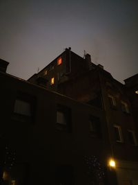 Low angle view of illuminated building against sky at night