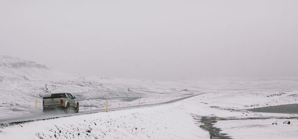 Snow covered landscape against sky