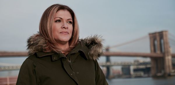 Portrait of young woman against sea