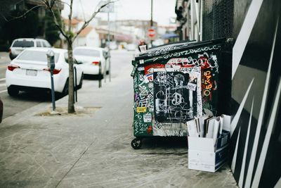 Graffiti on garbage bin at walkway