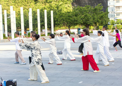 Rear view of people walking outdoors