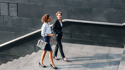 Young couple walking on staircase