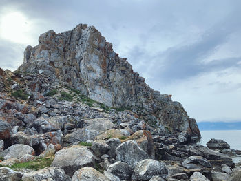 Rock formations in sea against sky