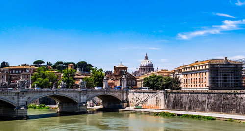 Ponte sant angelo over tiber river against st peter basilica