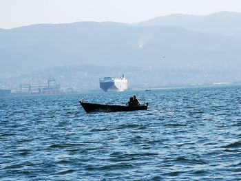 Boat sailing in sea against sky