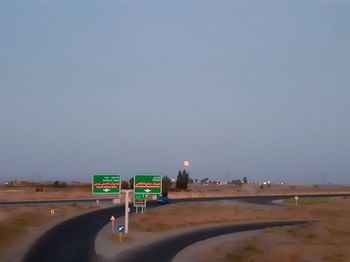 Road sign against clear sky