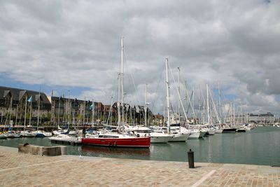 Boats in harbor with buildings in background