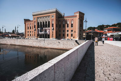 Buildings in city against clear sky