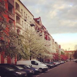 Buildings in city against cloudy sky