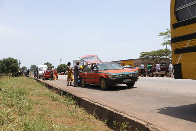 People on street in city against clear sky