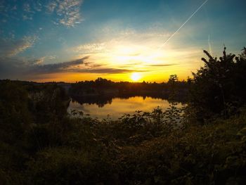 Scenic view of lake at sunset