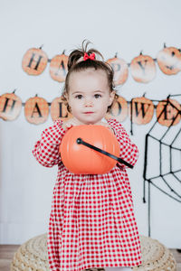 Portrait of cute baby girl standing on table