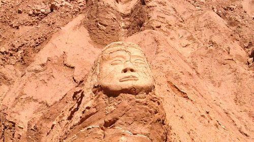 Low angle view of statue on sand