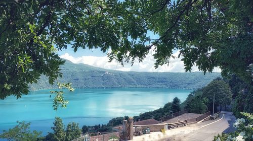 Scenic view of lake by mountains against sky