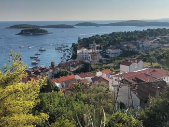 High angle view of townscape by sea against sky