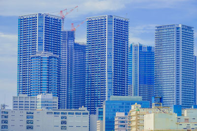 Modern buildings in city against sky