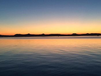 Scenic view of sea against clear sky during sunset