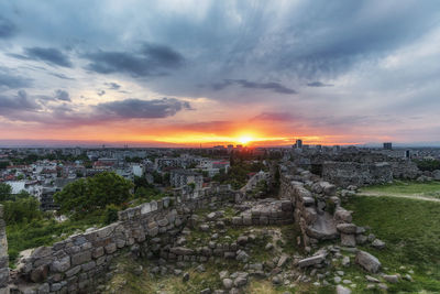 High angle view of buildings in city during sunset