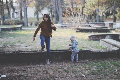 Full length of mother and son in park