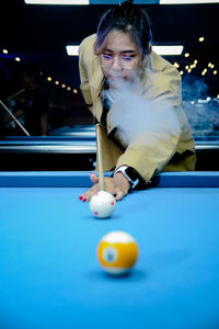 Portrait of boy playing pool