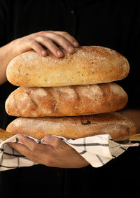 Midsection of person holding bread