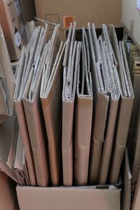 High angle view of folded cardboards in box at warehouse