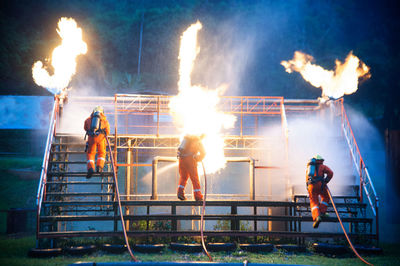 Firefighters extinguishing fire with hose