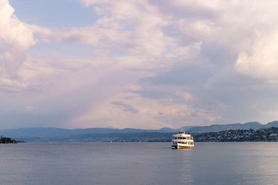 Ship sailing on sea against sky