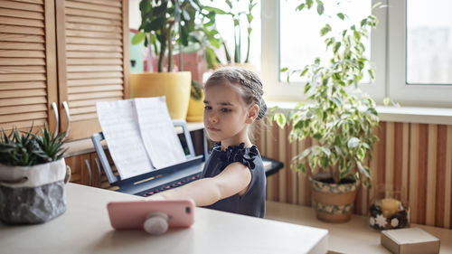 Girl playing piano at home