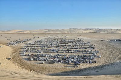 High angle view of crowd on sand against sky