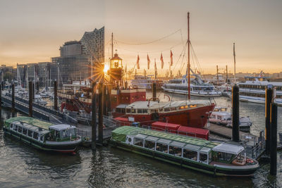Germany, hamburg,boats moored in harbor at sunrise
