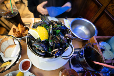 High angle view of mussels in container on table