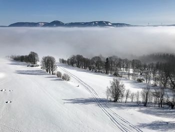 Scenic view of snow covered mountains against sky