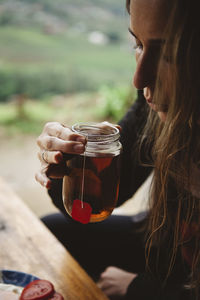 Cropped image of woman drinking tea