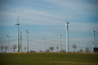 Traditional windmill on field against sky