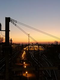 Railroad tracks against sky during sunset