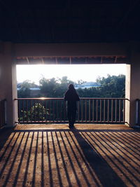 Rear view of silhouette man standing against sky