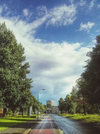 Country road against cloudy sky