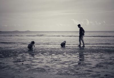 People on beach against sky