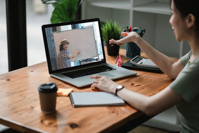 Woman talking on video call at office